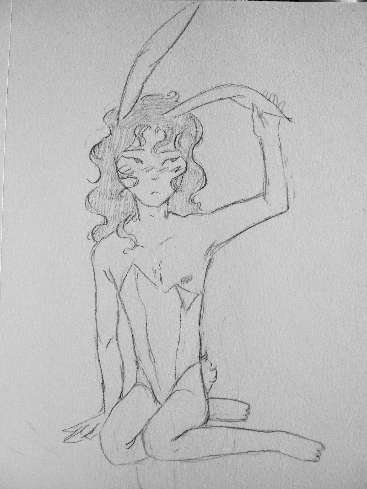 A pencil drawing. Yoshiki sitting on the floor in a sexy bunny outfit. Part of the top have meant to cover his chest has fallen, reveiling his nipple. He is reaching up with his arm to touch is bunny ear. He has long wavy hair.